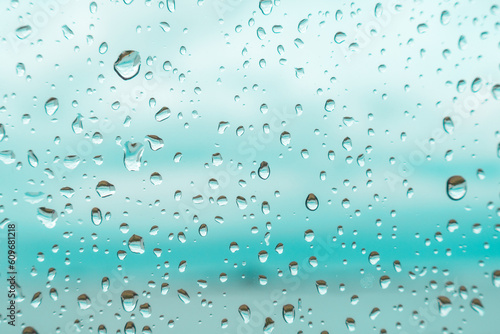 Drops on a window glass with blurry blue background