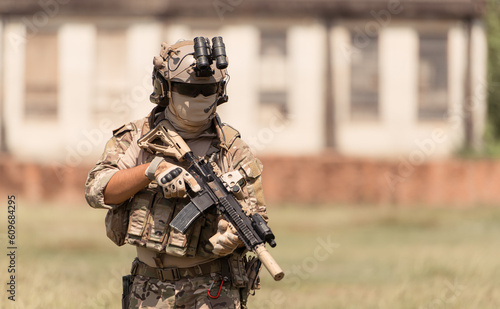 Special forces soldier in camouflage with a pair of weapons that are full of modern technology and complete for battle