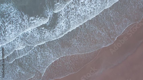 4K aerial view of calm ocean waves and sandy beach in Mandvi, Kutch, India. Top down view over ocean coast. Serene and Tranquil Landscape of beach. photo