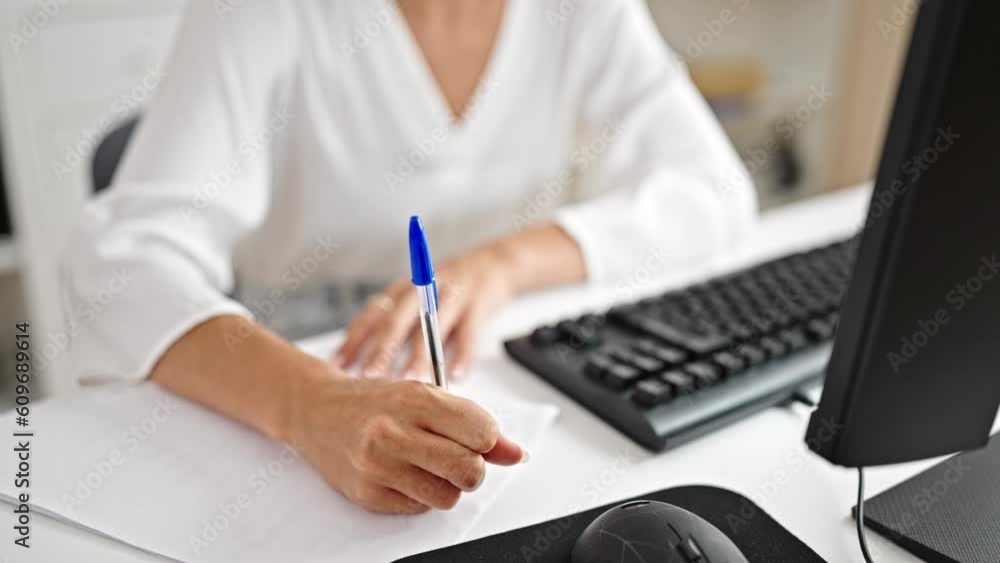 Young beautiful hispanic woman business worker writing on document thinking at office Young beautiful hispanic woman business worker writing on document thinking at office