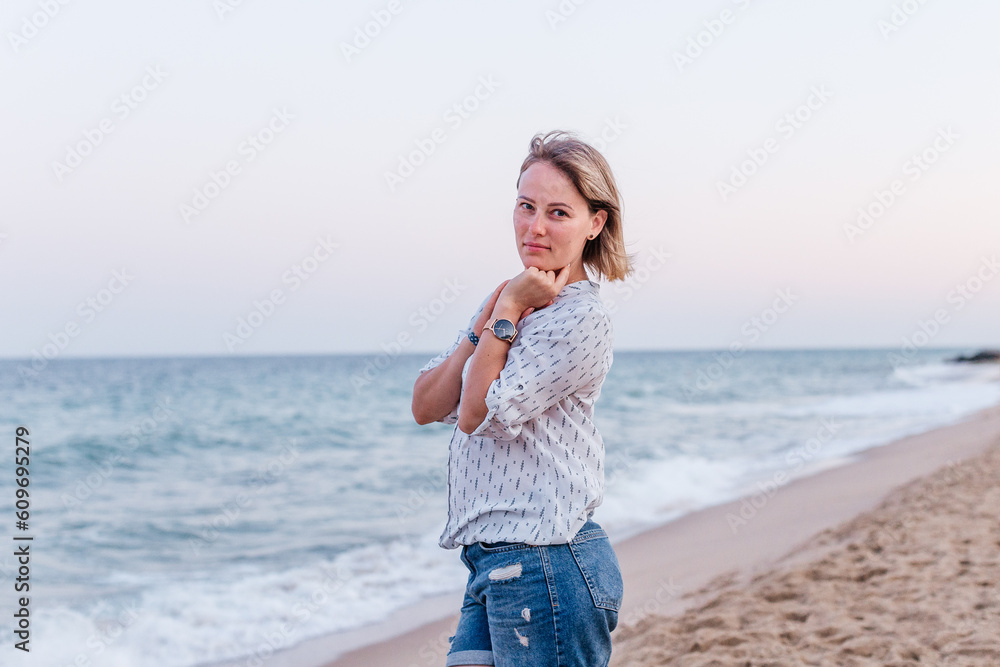 Portrait of a girl walking along the beach of the sea coast