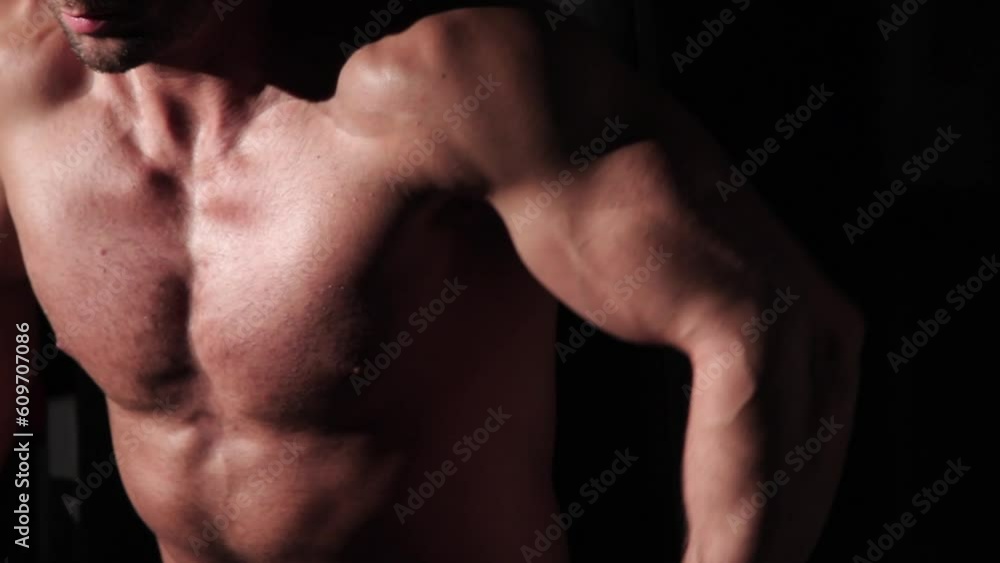 Young male athlete pumping his chest on a trainer. muscular bodybuilder Young male athlete pumping his chest on a trainer. muscular bodybuilder