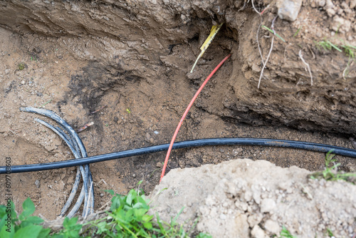 Принти на полотні Different cables for electricity and fiber optics are lying jumbled in the groun