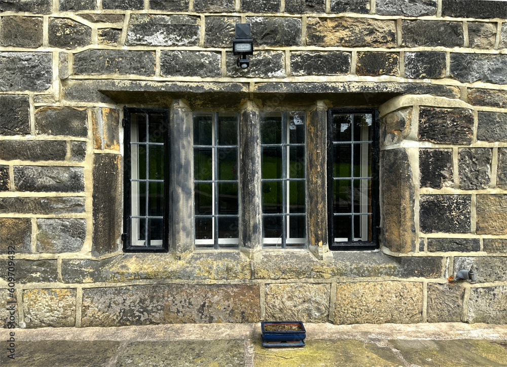 Obraz premium View of a 17th century, stone mullion window, in an old farmhouse near, Green Lane, Shelf, UK