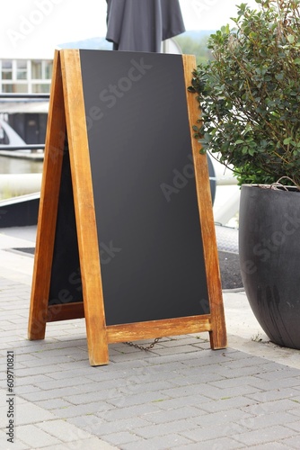 Empty menu board on a street, blank restaurant or cafe chalkboard.