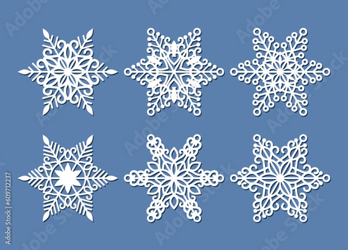 Set of laser cutting openwork snowflakes. Vector silhouette of christmas decoration. Template for paper isolated on blue background. Stencil for scrapbooking, carved wood.