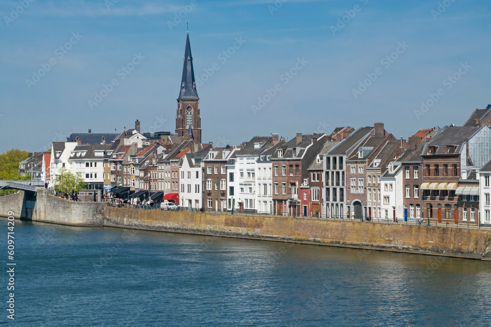 View of Maastricht skyline across Maas river in warm spring day in May, Maastricht, the Netherlands. Travel or leisure background.