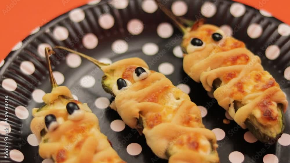 Jalapeno pepper mummies stuffed with cheese. Spooky halloween snack