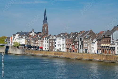 View of Maastricht skyline across Maas river in warm spring day in May, Maastricht, the Netherlands. Travel or leisure background.