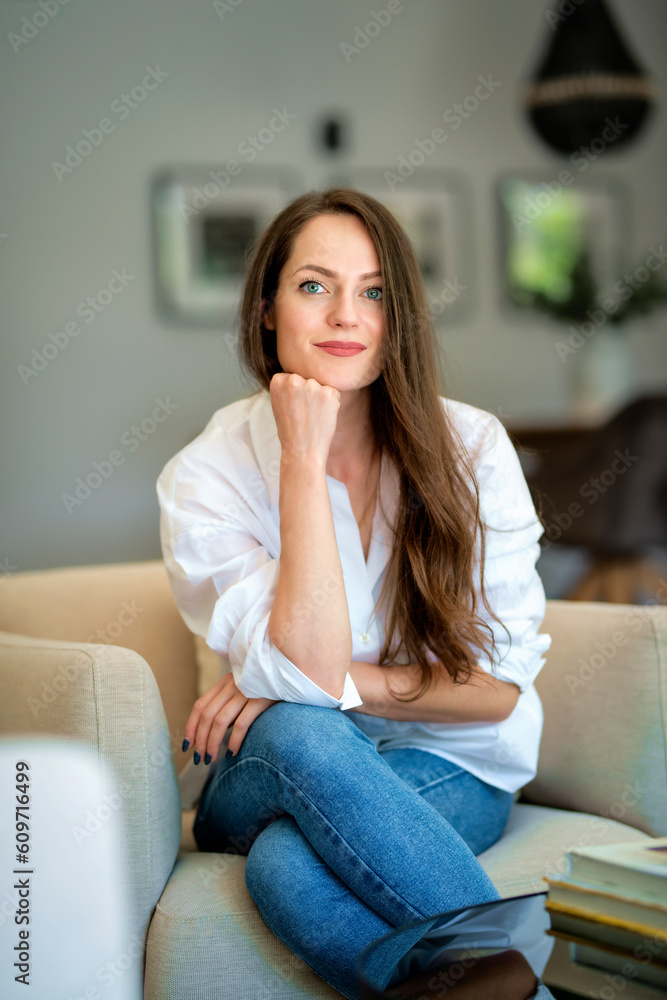 Portrait of an attractive young woman relaxing in her modern home