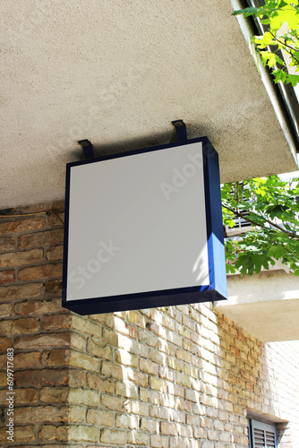 Blank white store sign design mockup. Street storefront shop, cafe, restaurant mounted signboard mock up design template.