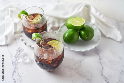 Cuba Libre with brown rum, cola and lime. Cuba Libre or long island cocktail. Focus Selective photo