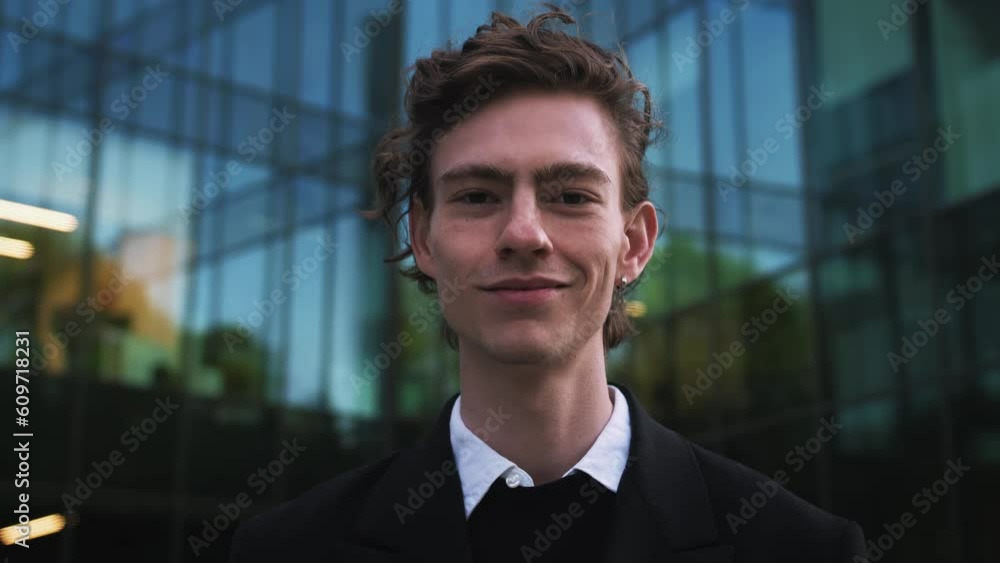 Portrait of smiling handsome businessman in formal wear standing near office. Head shot close up young happy banker advisor executive manager leader ceo owner entrepreneur investor looking at camera. Portrait of smiling handsome businessman in formal wear standing near office. Head shot close up young happy banker advisor executive manager leader ceo owner entrepreneur investor looking at camera.
