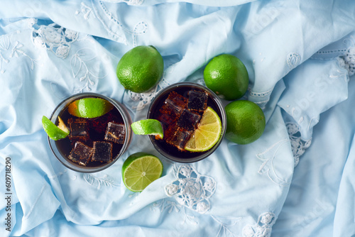 Фотография Cuba Libre in a glass with brown rum, cola, mint and lemon, caribbean drink for summer