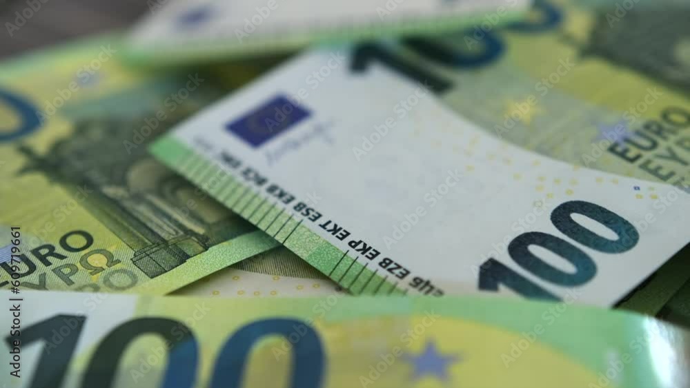 100 euros bills. Many paper money cash hundreds euro lies on wooden table. Importance of financial management in achieving long-term financial goals. 100 euros bills. Many paper money cash hundreds euro lies on wooden table. Importance of financial management in achieving long-term financial goals.
