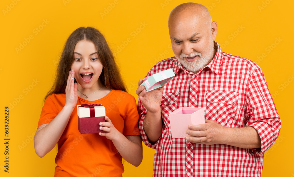surprised child and granddad with present box for anniversary surprised child and granddad with present box for anniversary