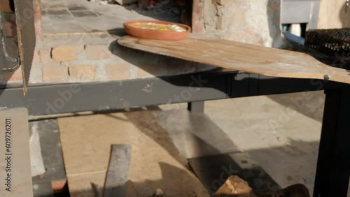 egg and cheese cooked in a clay pot in a traditional wood fire oven. It is taken out from oven by the cheff and shown to the camera