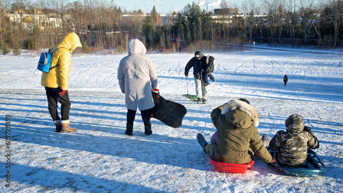 Obraz na plátně Toronto, Ontario / Canada - Jan 14, 2023: Family playing toboggan in winter