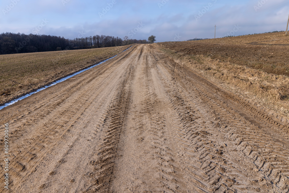 a broken country road at the beginning of spring a broken country road at the beginning of spring