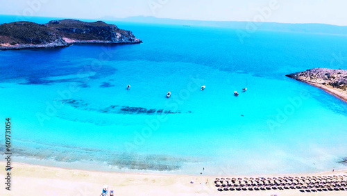 Aerial drone view of Greek island's sandy beach, turquoise crystal clear water, azure sea