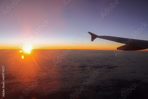 Atardecer con nubes desde ventanilla de avion photo