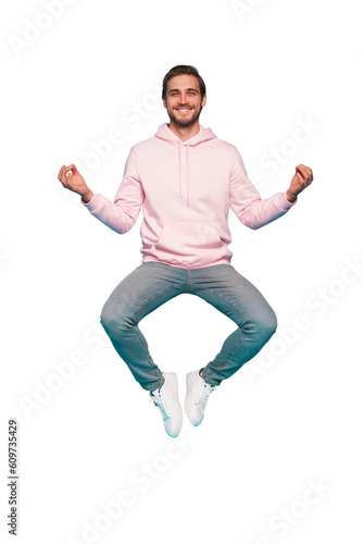 Full length body size photo of focused minded thoughtful man sitting doing yoga while jumping up in blue pants isolated on transparent background