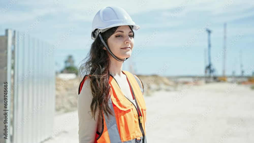 Young beautiful hispanic woman builder smiling confident standing with arms crossed gesture at street Young beautiful hispanic woman builder smiling confident standing with arms crossed gesture at street