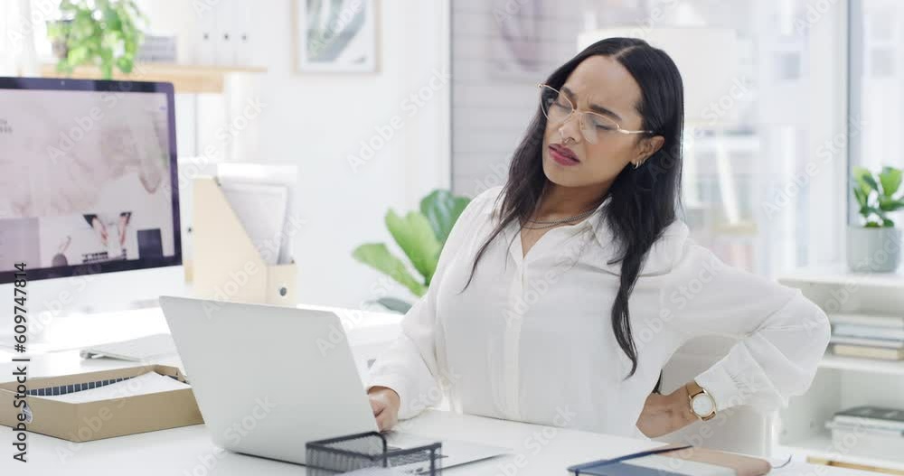 Business woman, laptop and back pain in burnout, discomfort or overworked on chair at the office. Upset female employee working on computer suffering bad ache, sore or muscle tension at the workplace Business woman, laptop and back pain in burnout, discomfort or overworked on chair at the office. Upset female employee working on computer suffering bad ache, sore or muscle tension at the workplace
