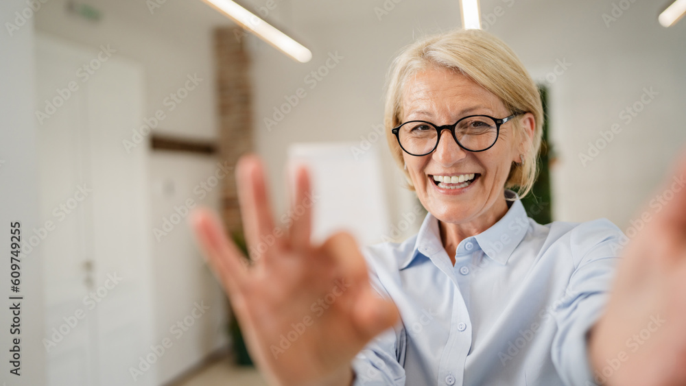 Portrait of one mature blonde caucasian woman with eyeglasses at home Portrait of one mature blonde caucasian woman with eyeglasses at home