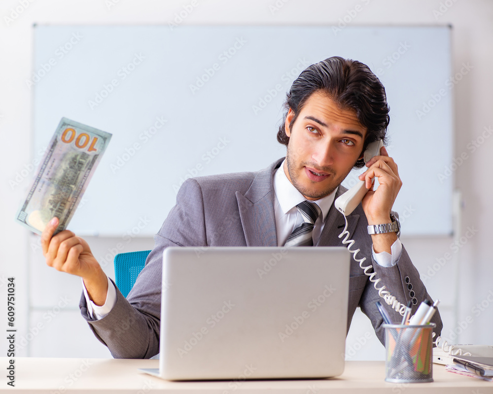 Young handsome businessman employee sitting in the office Young handsome businessman employee sitting in the office