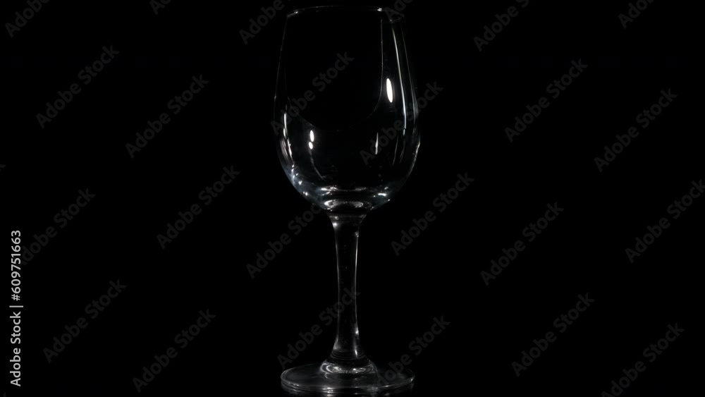 Lonely broken glass on black background. A view of abandoned broken wine glass spinning on the black background. A concept of love failure in people life. Lonely broken glass on black background. A view of abandoned broken wine glass spinning on the black background. A concept of love failure in people life.