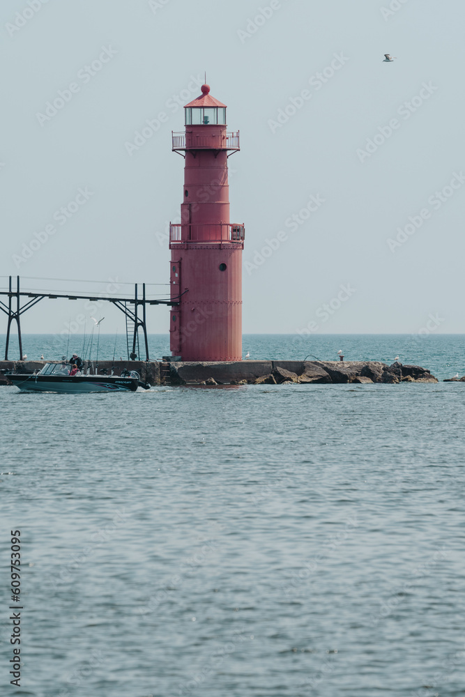 Algoma Pierhead Lighthouse - Lake Michigan, in Wisconsin, as a boat passes by
