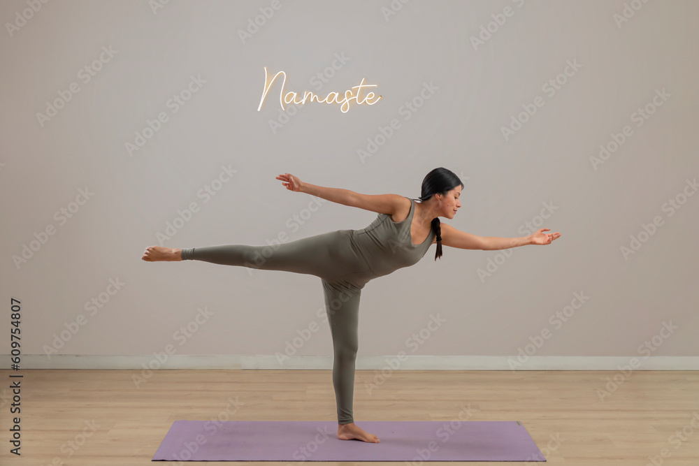 Young mexican woman practicing yoga indoors, standing doing a pose