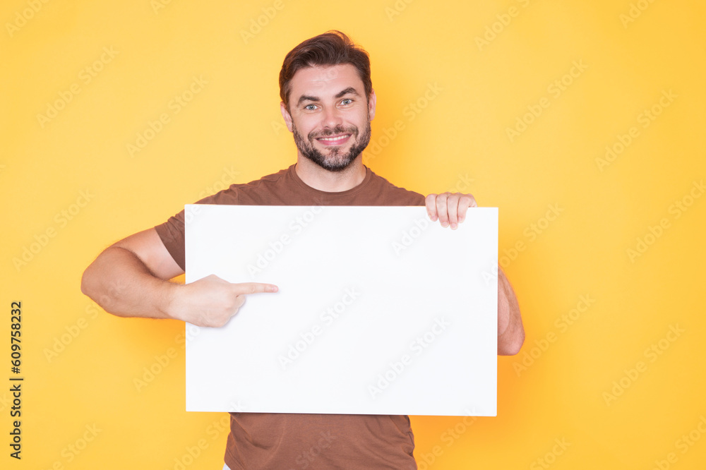 Information concept. Man with blank placard. Demonstrating copy space for your text or design. Man showing empty advertisement board on studio background. Blank placard, signboard for ad. Information concept. Man with blank placard. Demonstrating copy space for your text or design. Man showing empty advertisement board on studio background. Blank placard, signboard for ad.