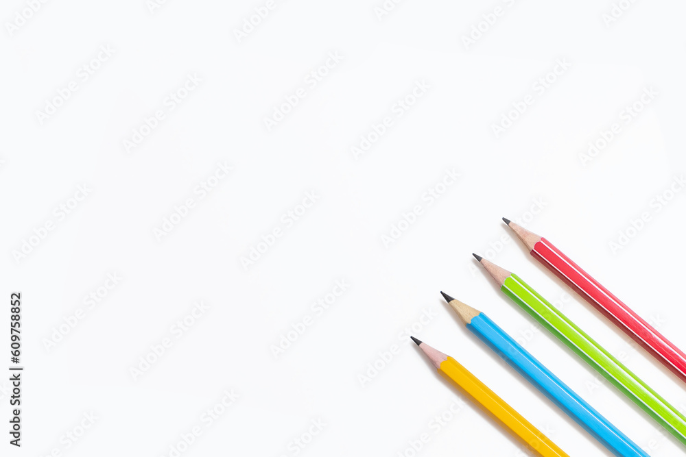 Four multi-colored pencils on a white background. Red, green, blue and yellow pencils. Free space for text. Pencils and empty space for text. The concept of learning or drawing Four multi-colored pencils on a white background. Red, green, blue and yellow pencils. Free space for text. Pencils and empty space for text. The concept of learning or drawing