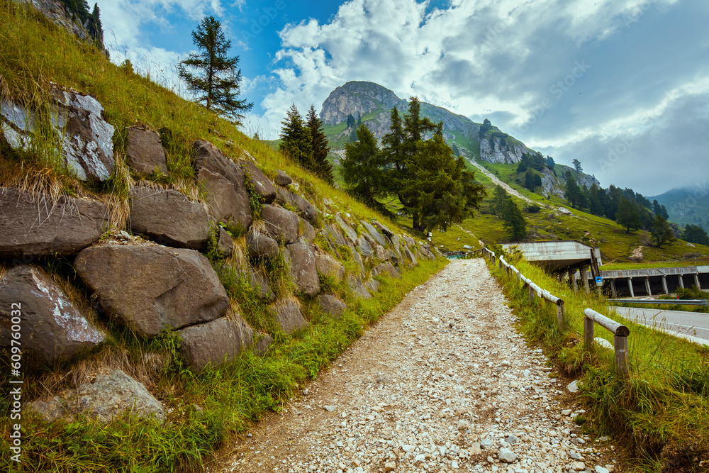 landscape with mountains, clouds, rocks, trees and trail