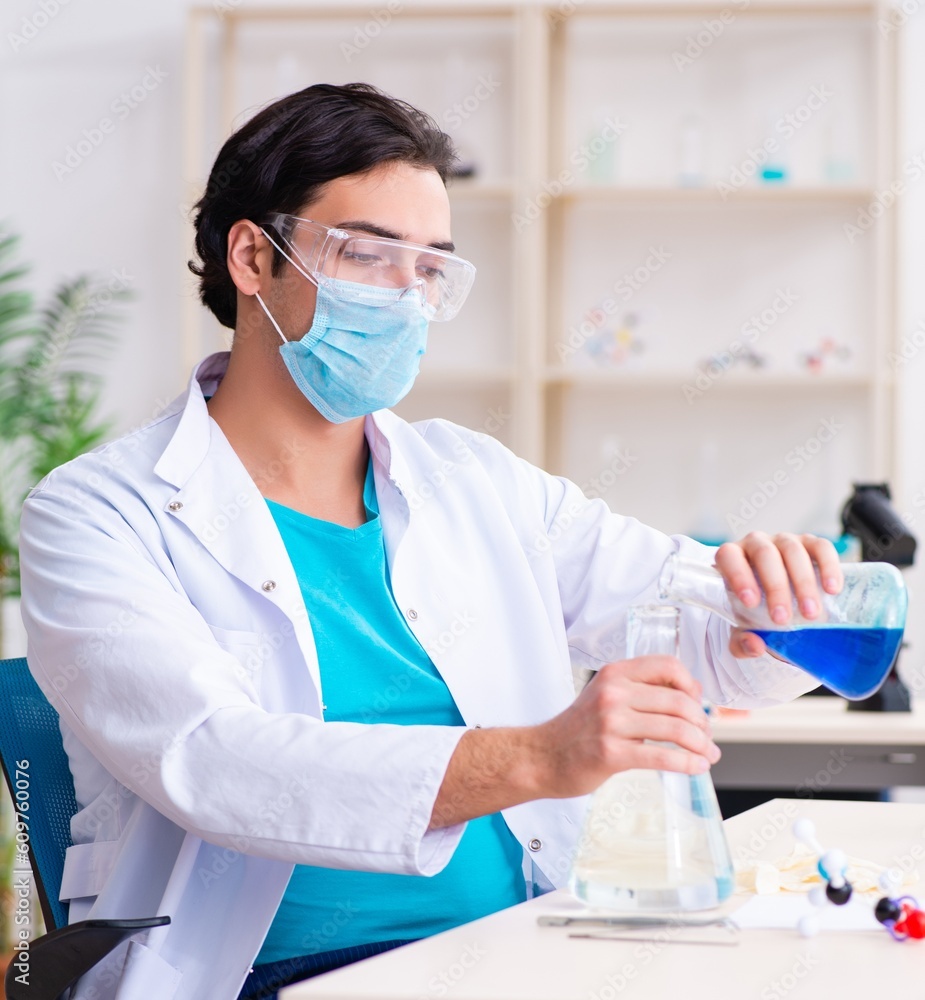Young male chemist working in the lab Young male chemist working in the lab