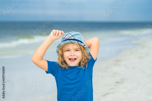 Excited face, amazed emotions of cute little kid boy on sea beach. Funny kids emotions. Outdoor close up portrait of a cute little child playing outdoor. Portrait of pretty little kids face outside.