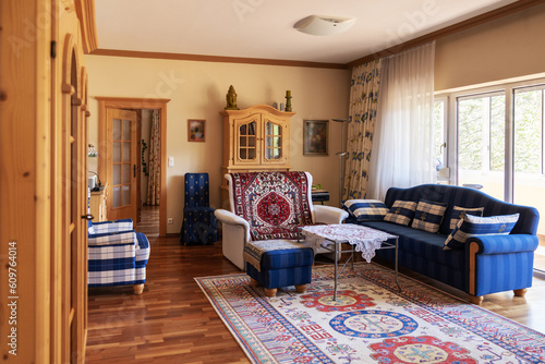 Private interior, a room with a sofa, armchairs, wardrobes and a large panoramic window with access to the loggia photo