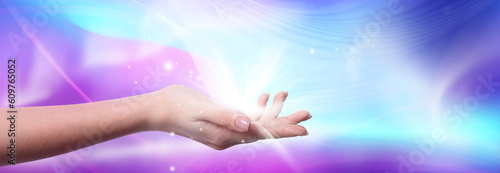Aura phenomena. Woman with flows of energy and lights around her hand against color background, closeup. Banner design