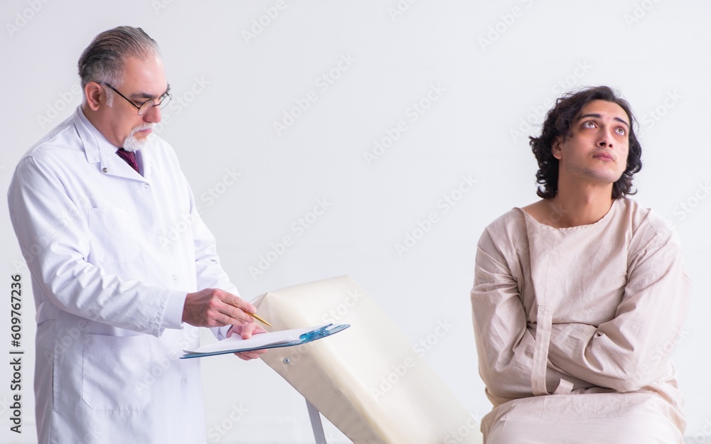 Fototapeta premium Aged male doctor psychiatrist examining young patient