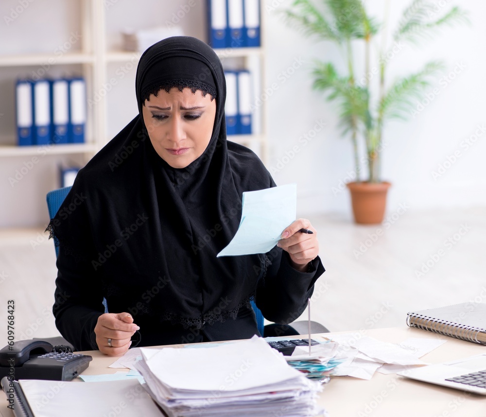 Female employee bookkeeper in hijab working in the office Female employee bookkeeper in hijab working in the office