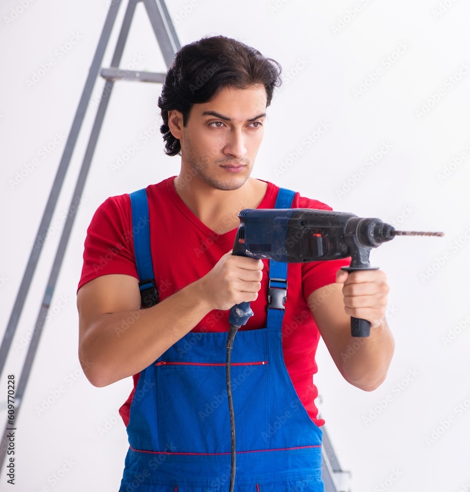 Young handsome contractor working indoors Young handsome contractor working indoors