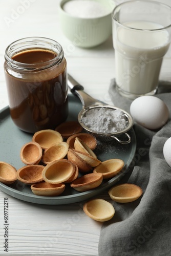 Ingredients for delicious walnut shaped cookies with condensed milk on white wooden table, closeup