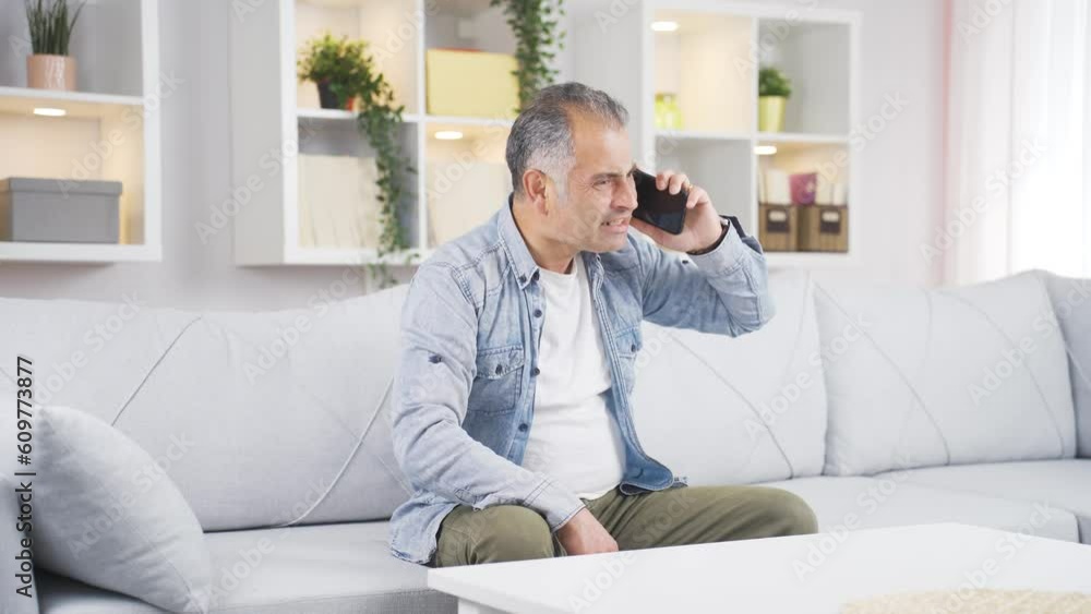 The man arguing with his wife on the phone takes off his ring. The man arguing with his wife on the phone takes off his ring.