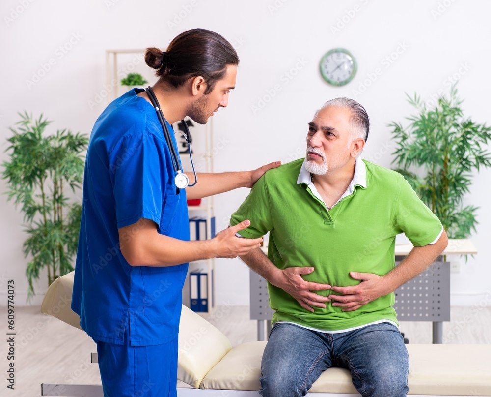 Fototapeta premium Old man visiting young male doctor gastroenterologist