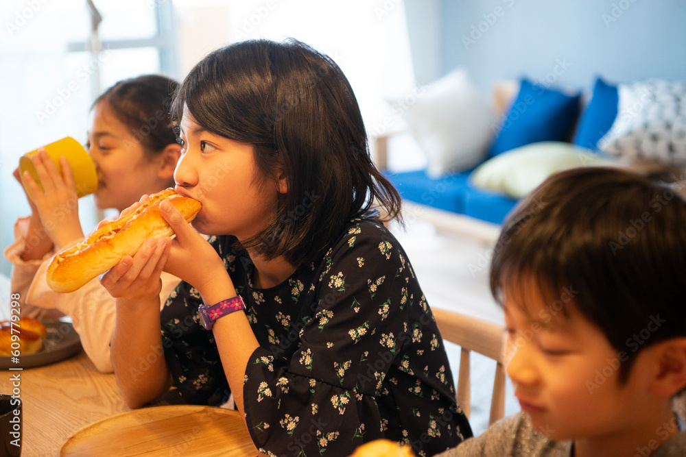 カウンターでパンを食べている子供たち Stock Photo | Adobe Stock