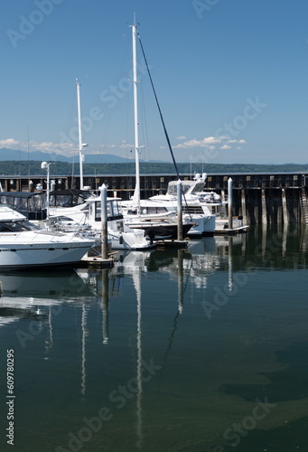 Reflections of white boat masts at Edmonds marina