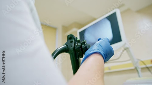 Close-up of doctor's gloved hand with endoscope during diagnostic gastroscopy or colonoscopy in clinic
