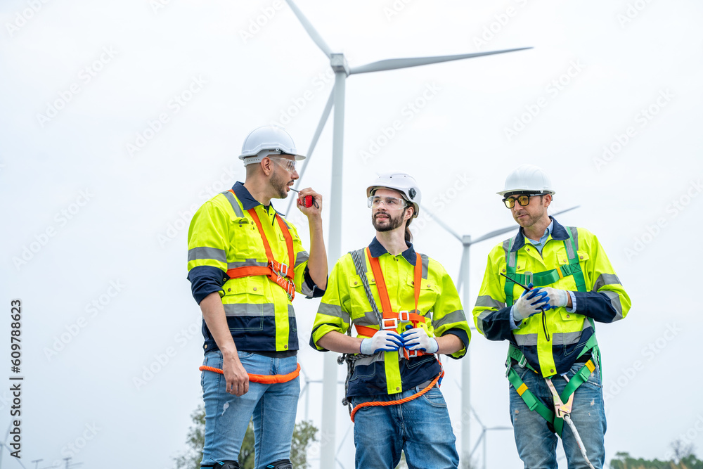 Engineer with technician are inspection work in wind turbine farms rotation to generate electricity energy. Engineer with technician are inspection work in wind turbine farms rotation to generate electricity energy.